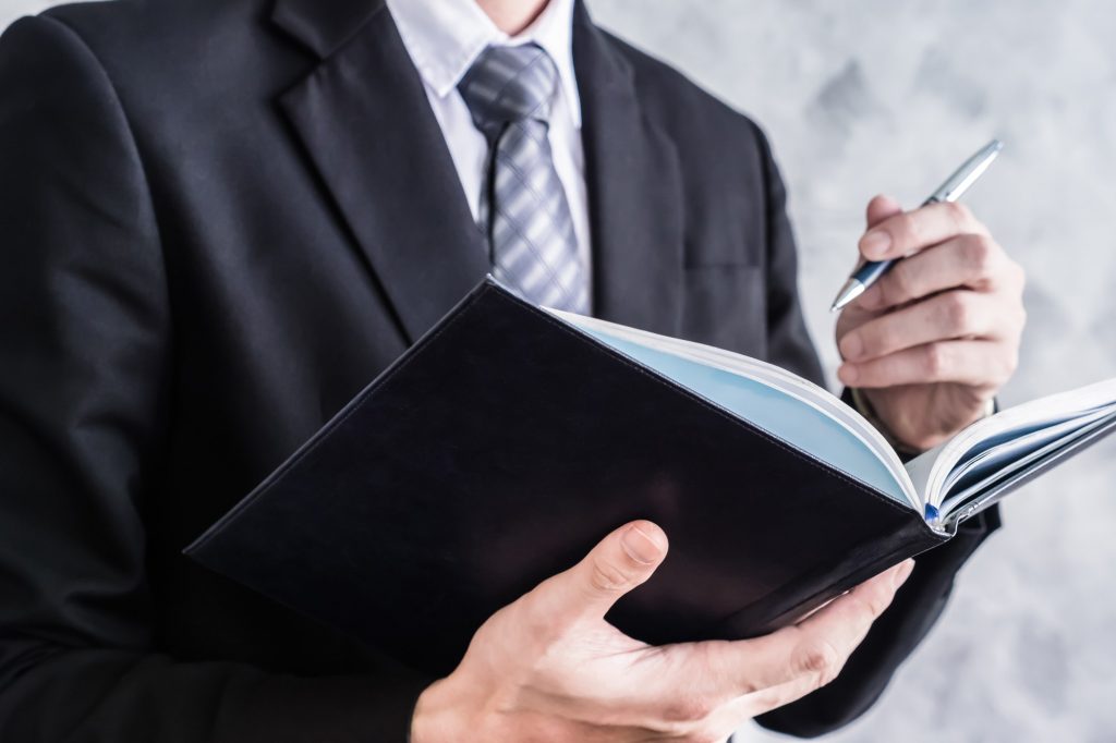 Close up of businessman checking documents on grunge background.